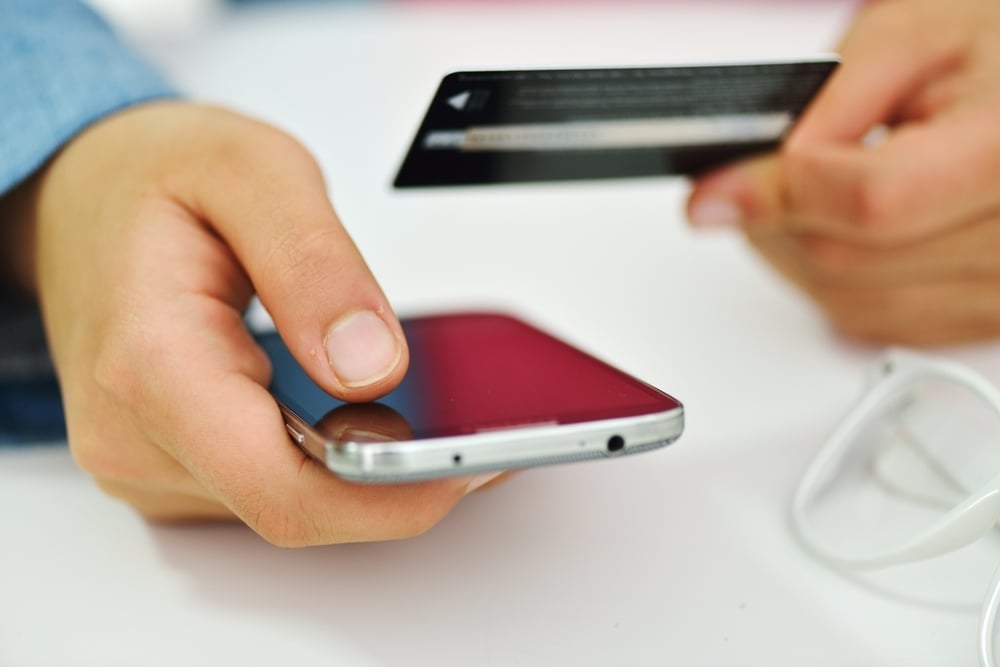 Human hand on tablet pc and credit card for shopping online Human hand on tablet pc and credit card for shopping online